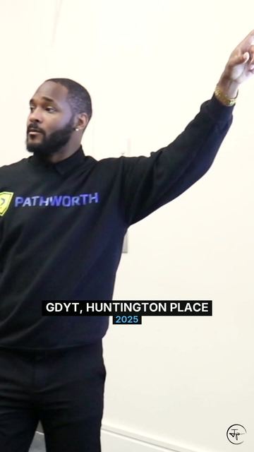 Jermaine pointing to the screen at GDYT, Huntington Place, 2025